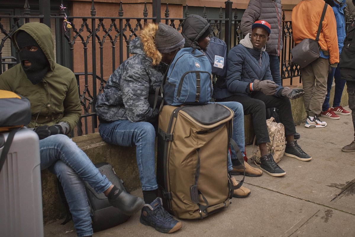 Migrants queue in the cold