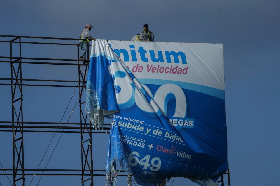 Workers remove an advertisement on a billboard ahead of Hurricane Beryl in Playa del Carmen, Mexico (Copyright 2024 The Associated Press. All rights reserved)